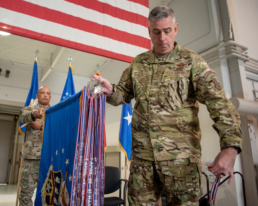 Col. Bruce Bancroft, 123rd Airlift Wing commander, pins a streamer to the unit colors during a ceremony at the Kentucky Air National Guard Base in Louisville, Ky., Oct. 14, 2023. The streamer signifies the unit’s selection for the Meritorious Unit Award, continuing its legacy as one of the most decorated organizations in U.S. Air Force history. (U.S. Air National Guard photo by Tech. Sgt. Joshua Horton)
