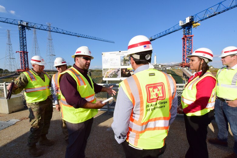 Supervisory Navigation Facility Specialist Caleb Skinner briefs Secretary of the Army for Civil Works Michael L. Connors and Stacey Brown, deputy assistant secretary of the Army for Management and Budget, about operations at the active navigation lock Oct. 12, 2023, during a tour on the Tennessee River in Grand Rivers, Kentucky. (USACE Photo by Lee Roberts)