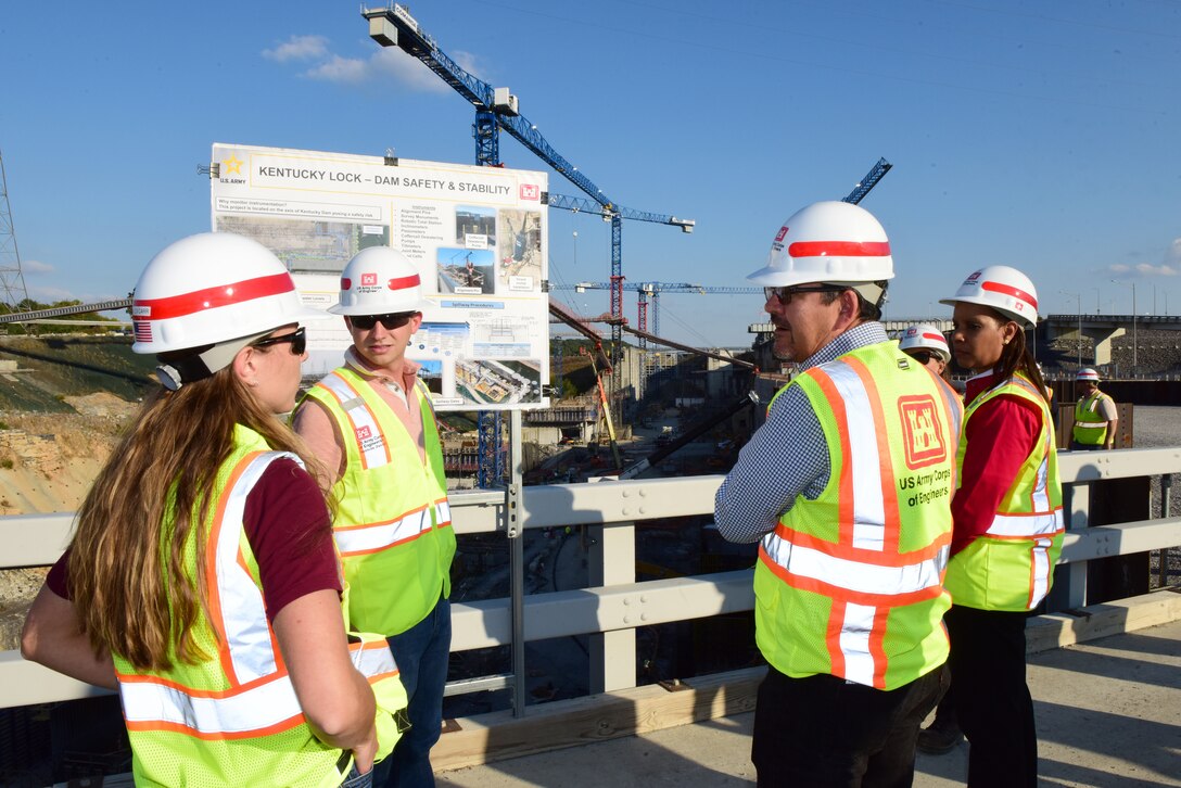 Alex Carr (Left) and Dustin Burkett (Second from Left) brief Secretary of the Army for Civil Works Michael L. Connors and Stacey Brown, deputy assistant secretary of the Army for Management and Budget, about dam safety and stability Oct. 12, 2023, during a tour of the Kentucky Lock Addition Project on the Tennessee River in Grand Rivers, Kentucky. (USACE Photo by Lee Roberts)