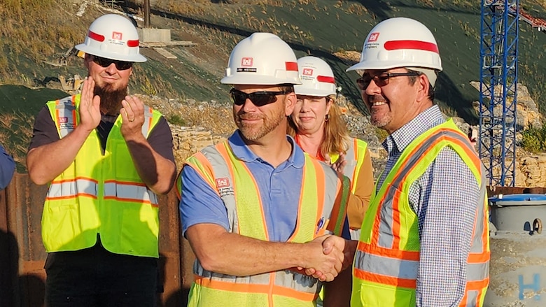Secretary of the Army for Civil Works Michael L. Connors (Right) presents a challenge coin recognizing excellence to Jody Robinson for his work on the Kentucky Lock Addition Project while touring the project Oct. 12, 2023, on the Tennessee River in Grand Rivers, Kentucky. (USACE Photo by Vanessa Rudd)