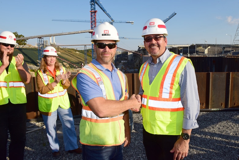 Secretary of the Army for Civil Works Michael L. Connors presents a challenge coin recognizing excellence to Jody Robinson for his work on the Kentucky Lock Addition Project while touring the project Oct. 12, 2023, on the Tennessee River in Grand Rivers, Kentucky. (USACE Photo by Lee Roberts)
