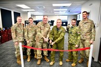 The Continental North American Aerospace Defense Command Region deputy commander, Royal Canadian Air Force Maj. Gen. Sean Boyle, center-right, and the Washington Air National Guard commander, U.S. Air Force Brig. Gen. Gent Welsh center-left, cut the ribbon on the Western Air Defense Sector’s new Mission Training Center with WADS leadership Oct. 5, 2023, on Joint Base Lewis-McChord, Wash. The $2 million state-of-the-art facility provides high-end simulation capabilities for Airmen who manage and operate Command and Control Battle Management Systems in defense of the U.S. homeland under Operation NOBLE EAGLE.