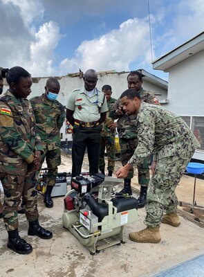 Engineman 1st Class Benfry Dejesus demonstrates start up procedures for an ultra-low volume truck mounted sprayer to Ghana Armed Forces (GAF) service members during an Operational Pest Management Equipment Training (OPMET) in Accra, Ghana, July 13, 2023. The training exercise introduced GAF members to skills needed to conduct pest management surveillance as well as proper use, maintenance, troubleshooting, and field repair of pesticide application equipment for operational military forces. (U.S. Navy photo by Lt. j.g. John So)
