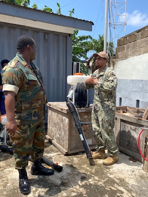 Engineman 1st Class Benfry Dejesus answers a question regarding a Stihl backpack sprayer during an Operational Pest Management Equipment Training (OPMET) in Accra, Ghana, July 13, 2023. The training exercise introduced GAF members to skills needed to conduct pest management surveillance as well as proper use, maintenance, troubleshooting, and field repair of pesticide application equipment for operational military forces. (U.S. Navy photo by Lt. j.g. John So)