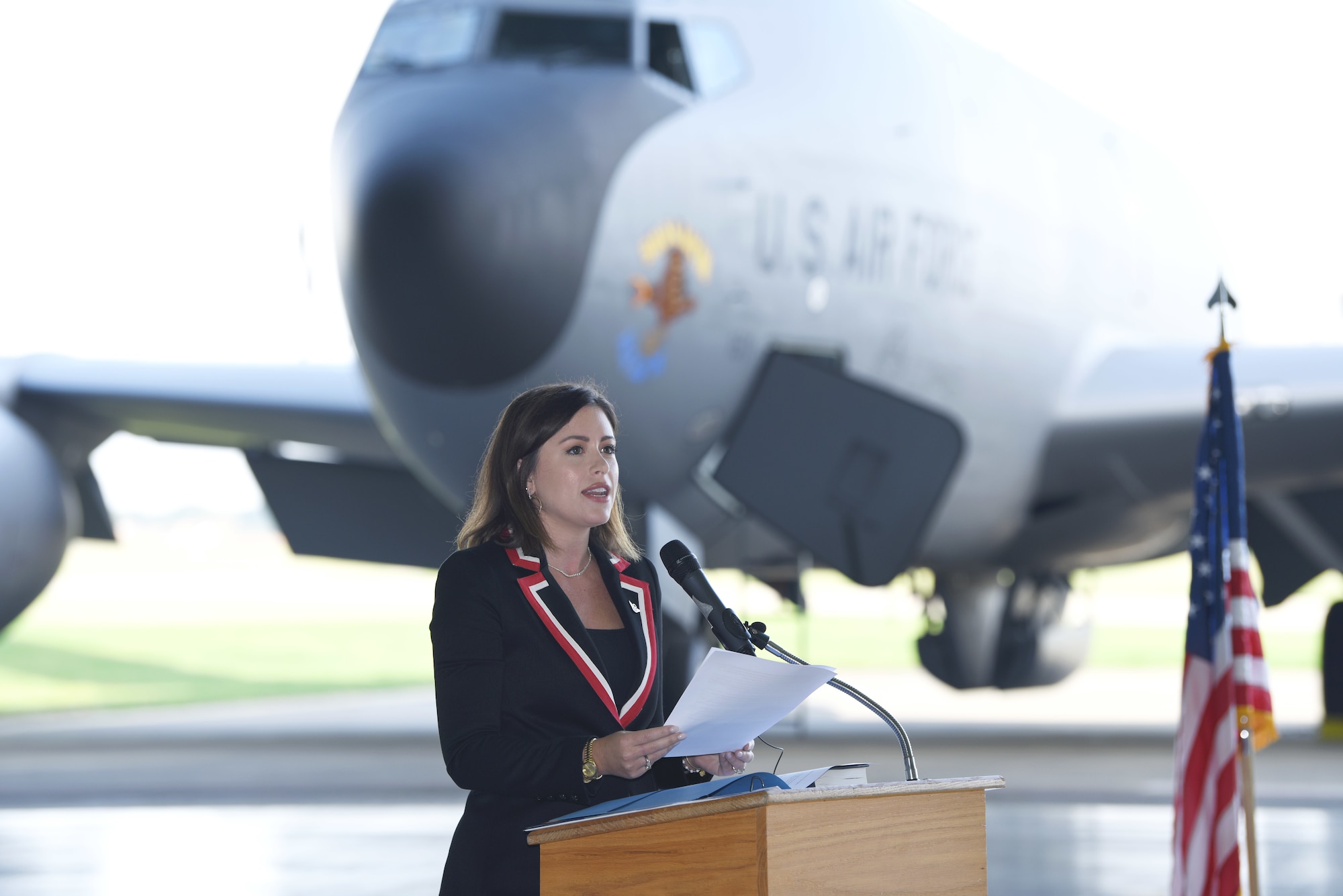 Chloe Melas, granddaughter of Capt. Frank Murphy, 100th Bomb Group veteran and B-17 Flying Fortress navigator, shares some of her grandfather’s memories and experiences during his time flying combat missions out of Thorpe Abbotts, Norfolk, England, during World War II at the nose art dedication ceremony at Royal Air Force Mildenhall, England, Oct. 10, 2023. The ceremony saw the unveiling of the two latest heritage nose art on KC-135 Stratotankers from the 100th Air Refueling Wing. (U.S. Air Force photo by Karen Abeyasekere)