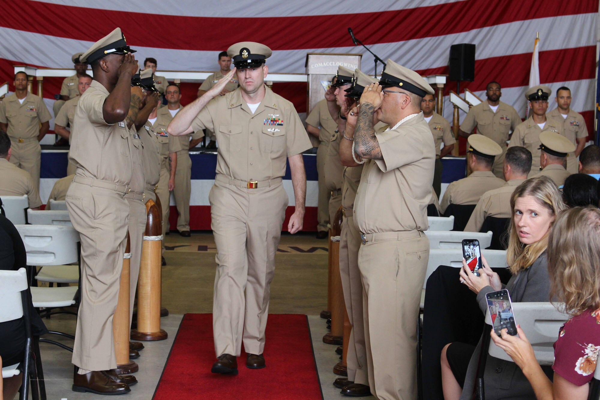 NIWC Atlantic joined forces with the Airborne Command & Control and Logistics Wing (ACCLOGWING) for the 2023 Navy Chief Petty Officer Pinning ceremony hosted by VAW-120 on Sept. 29 at 10:00am in LP-34 Hangar, Norfolk, VA. NIWC Atlantic's YNC Bilaal Porter, ITC Nick Mayer, LSC Matthew Hughes, ITC Jereyme Nova, and OSC Tonya Booker, along with 20 other ACCLOGWING CPO Selectees had their anchors pinned on and their caps donned during the traditional Navy ceremony.  NIWC Atlantic's GySgt Regino Rosales (USMC) also completed the precursor CPO season training and was recognized as an Honorary Navy Chief Petty Officer.