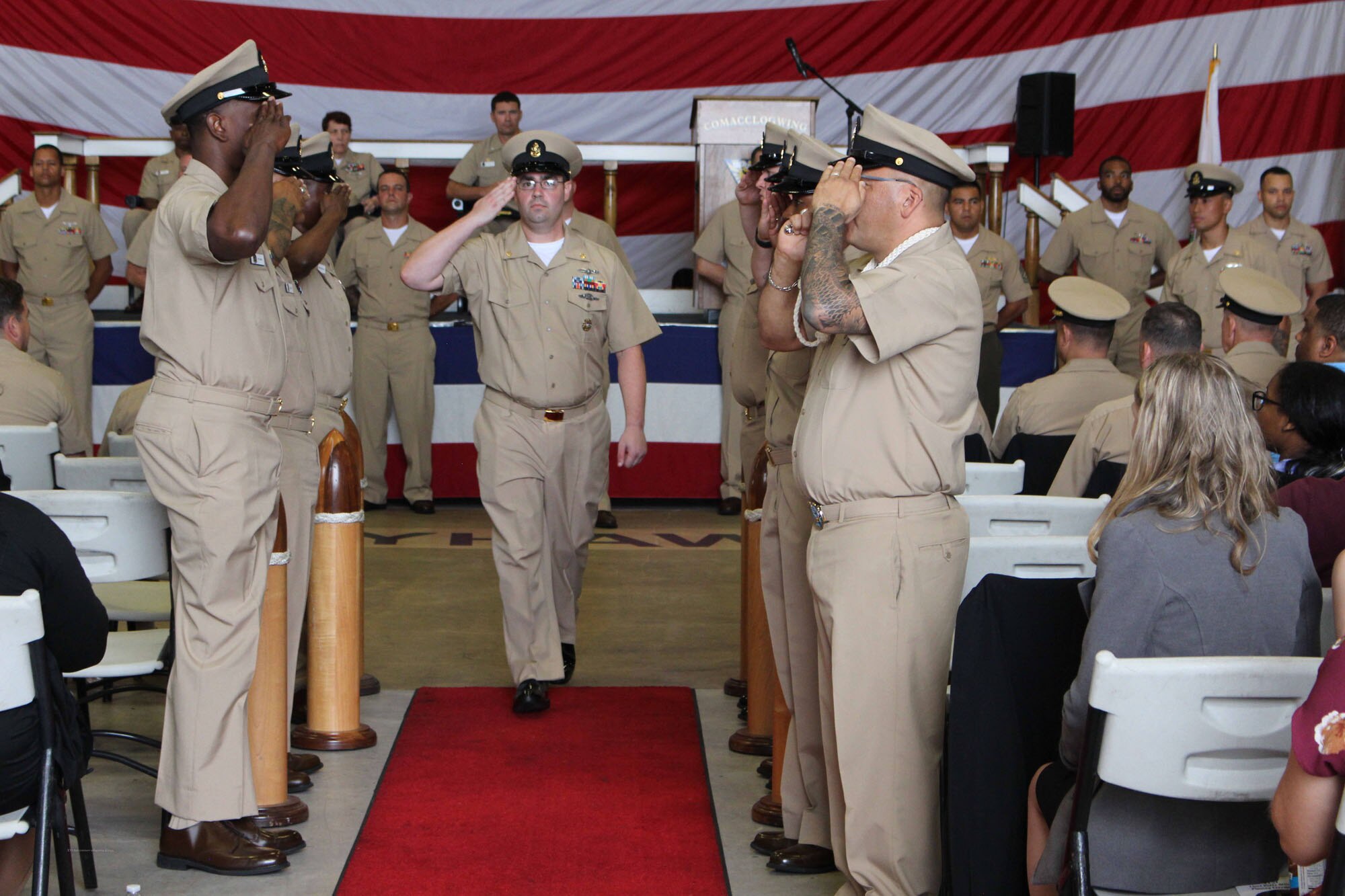 NIWC Atlantic joined forces with the Airborne Command & Control and Logistics Wing (ACCLOGWING) for the 2023 Navy Chief Petty Officer Pinning ceremony hosted by VAW-120 on Sept. 29 at 10:00am in LP-34 Hangar, Norfolk, VA. NIWC Atlantic's YNC Bilaal Porter, ITC Nick Mayer, LSC Matthew Hughes, ITC Jereyme Nova, and OSC Tonya Booker, along with 20 other ACCLOGWING CPO Selectees had their anchors pinned on and their caps donned during the traditional Navy ceremony.  NIWC Atlantic's GySgt Regino Rosales (USMC) also completed the precursor CPO season training and was recognized as an Honorary Navy Chief Petty Officer.