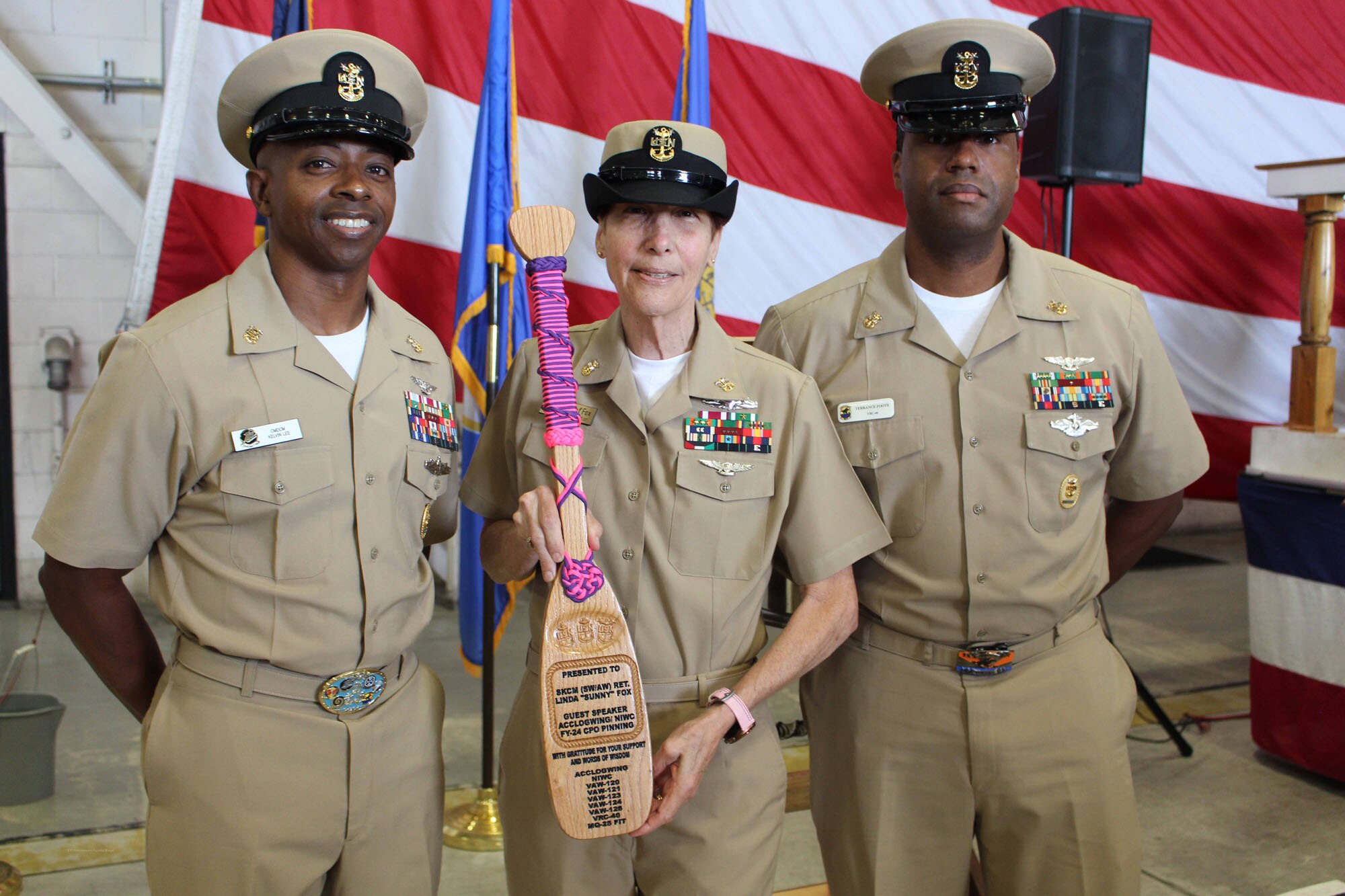 NIWC Atlantic joined forces with the Airborne Command & Control and Logistics Wing (ACCLOGWING) for the 2023 Navy Chief Petty Officer Pinning ceremony hosted by VAW-120 on Sept. 29 at 10:00am in LP-34 Hangar, Norfolk, VA. NIWC Atlantic's YNC Bilaal Porter, ITC Nick Mayer, LSC Matthew Hughes, ITC Jereyme Nova, and OSC Tonya Booker, along with 20 other ACCLOGWING CPO Selectees had their anchors pinned on and their caps donned during the traditional Navy ceremony.  NIWC Atlantic's GySgt Regino Rosales (USMC) also completed the precursor CPO season training and was recognized as an Honorary Navy Chief Petty Officer.