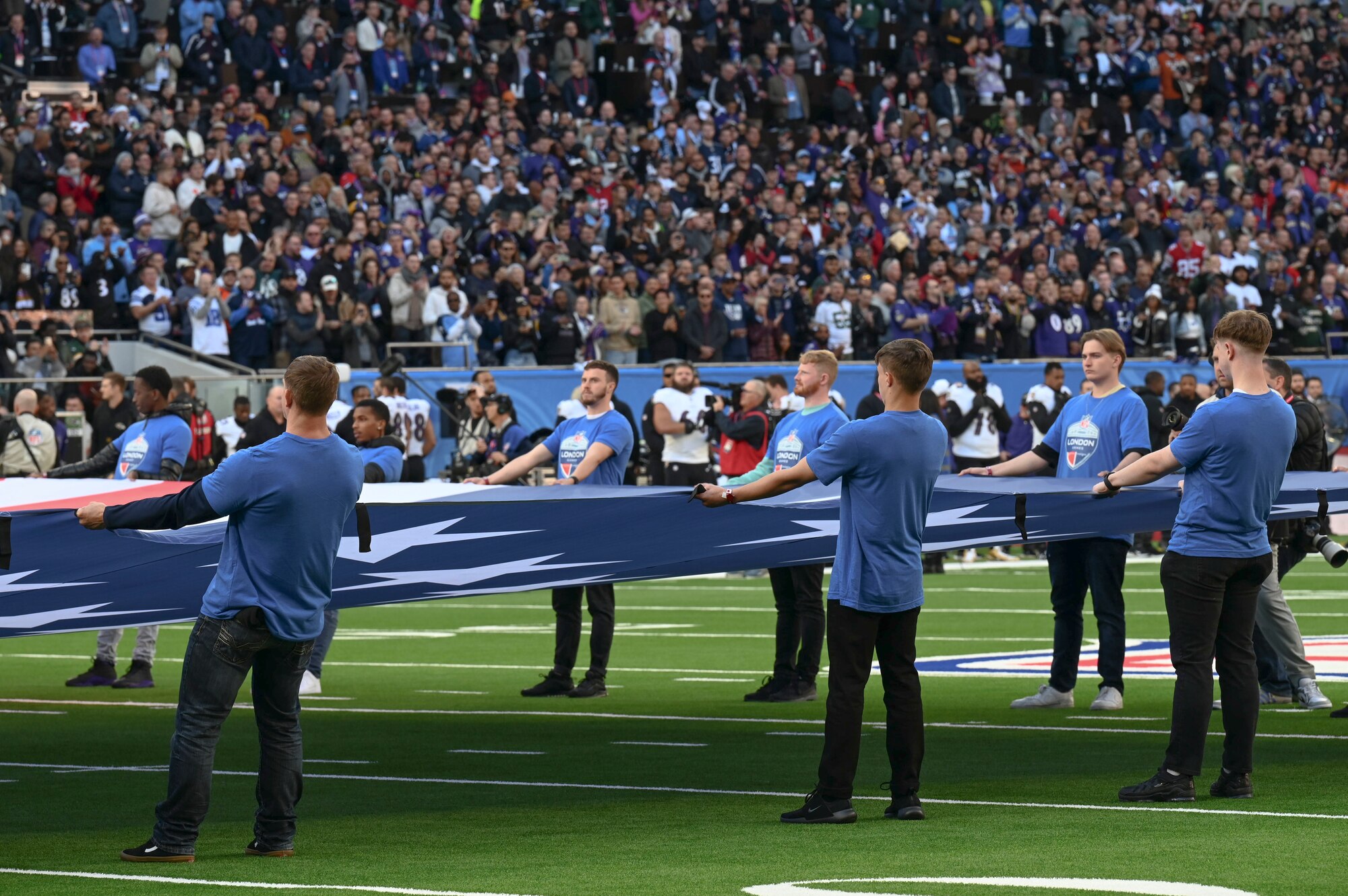 As part of the pre-game ceremony, Airmen presented a U.S. flag alongside a U.K. flag presented by British service members.