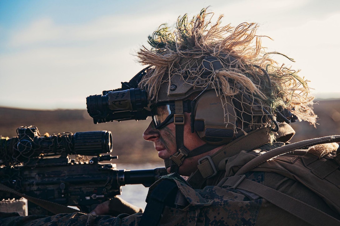 A soldier holding a weapon provides security during a training exercise.