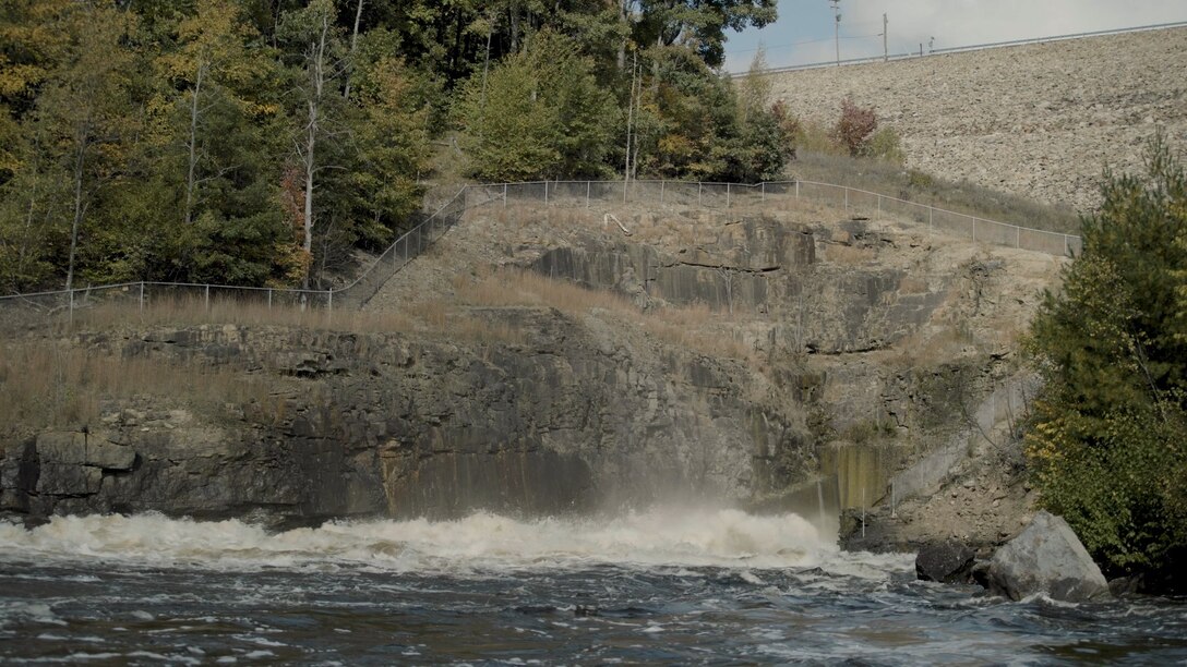 Photo shows whitewater conditions and the outlet area of a dam