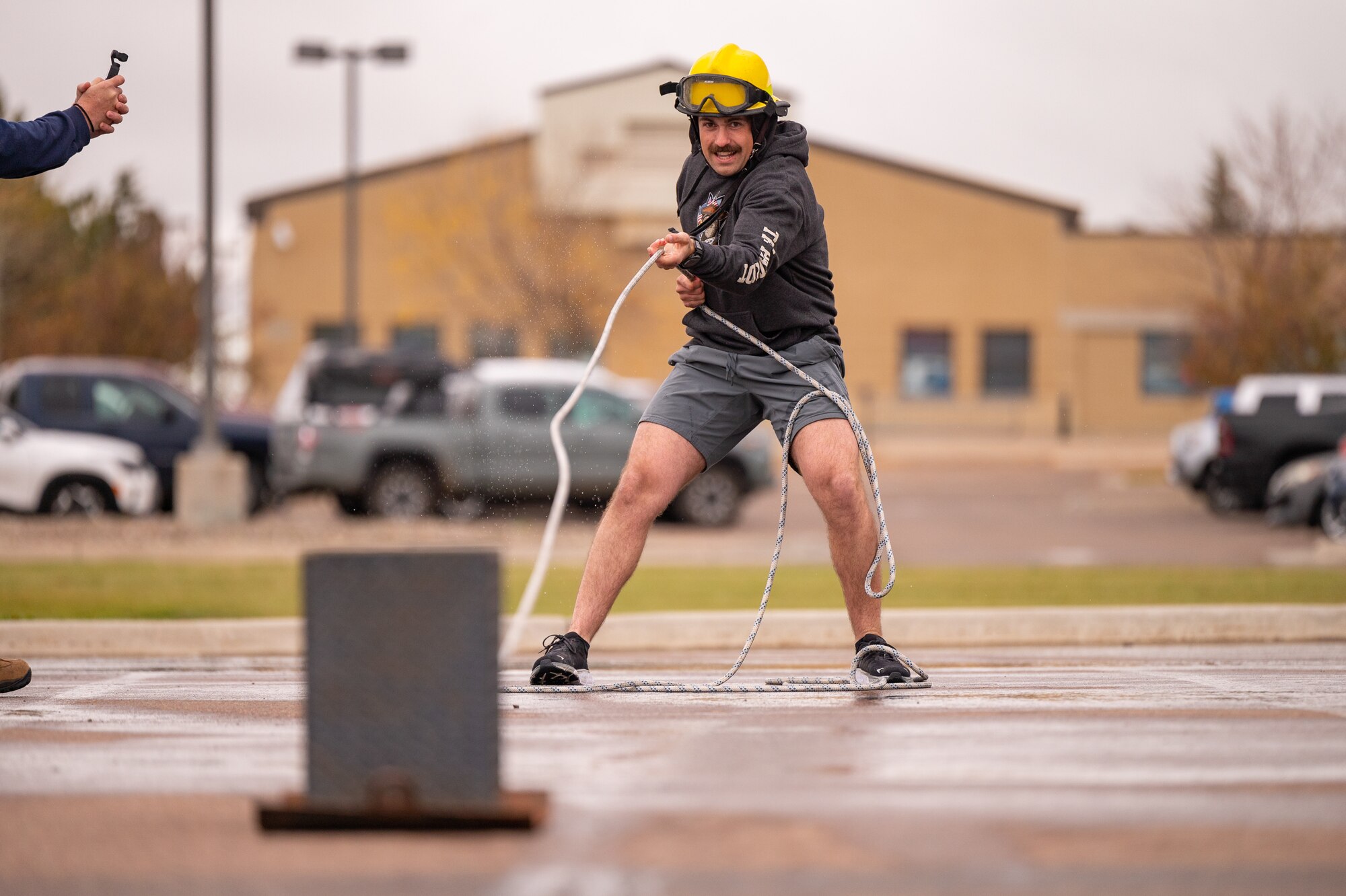 A man pulling a metal sled.