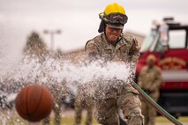 A man spraying a basketball.