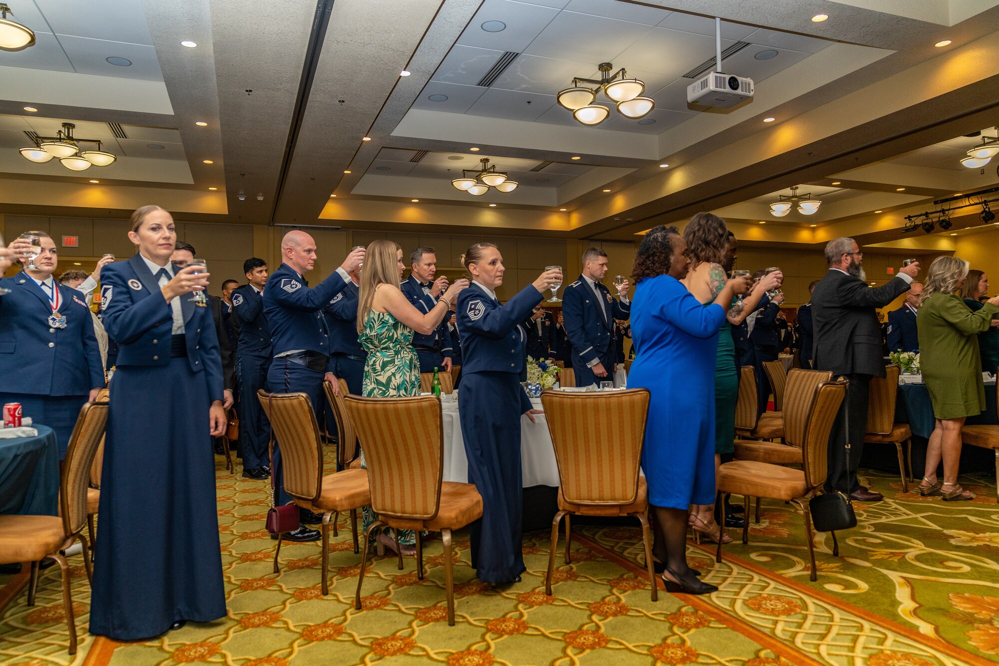 81st Training Wing Airmen, families and friends raise a glass to toast the POW/MIA table during the Senior Noncommissioned Officer Induction Ceremony at Keesler Air Force Base, Mississippi, Oct. 13, 2023.