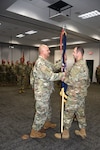 Lt. Col. Nathan Bennington receives the colors of the 426t Regiment from Brig. Gen. Matthew Strub, Wisconsin’s deputy adjutant general for Army, during a formal change of command ceremony Oct. 14 at the Wisconsin Military Academy, Fort McCoy, Wis.