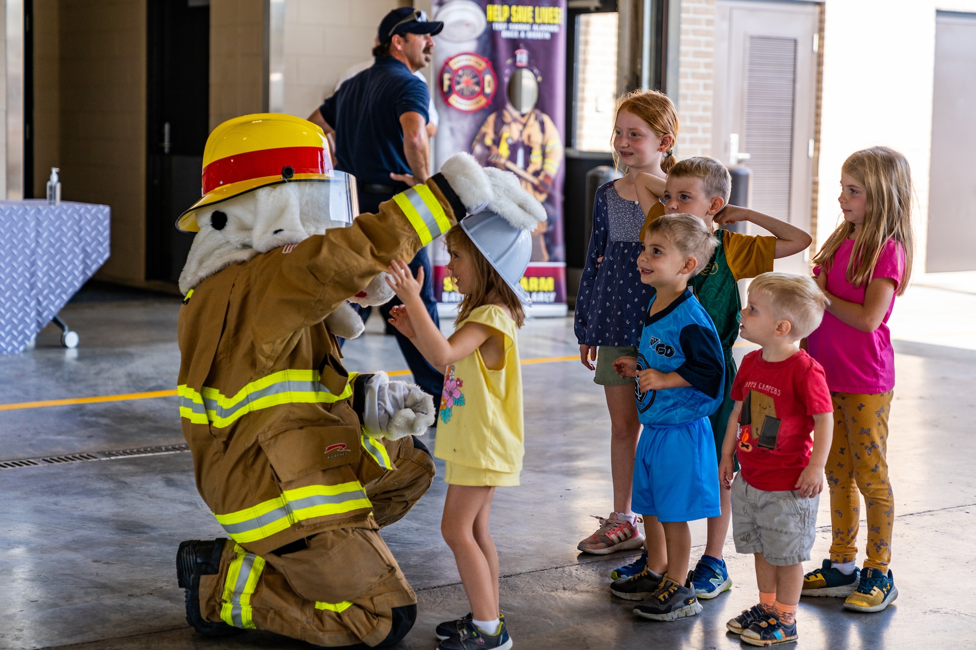 Sparky the Fire Dog, the official mascot of the National Fire Protection Association, welcomes kids to the Keesler Fire Department during the Fire Safety and Preparedness Event at Keesler Air Force Base, Mississippi, Oct. 14, 2023.
