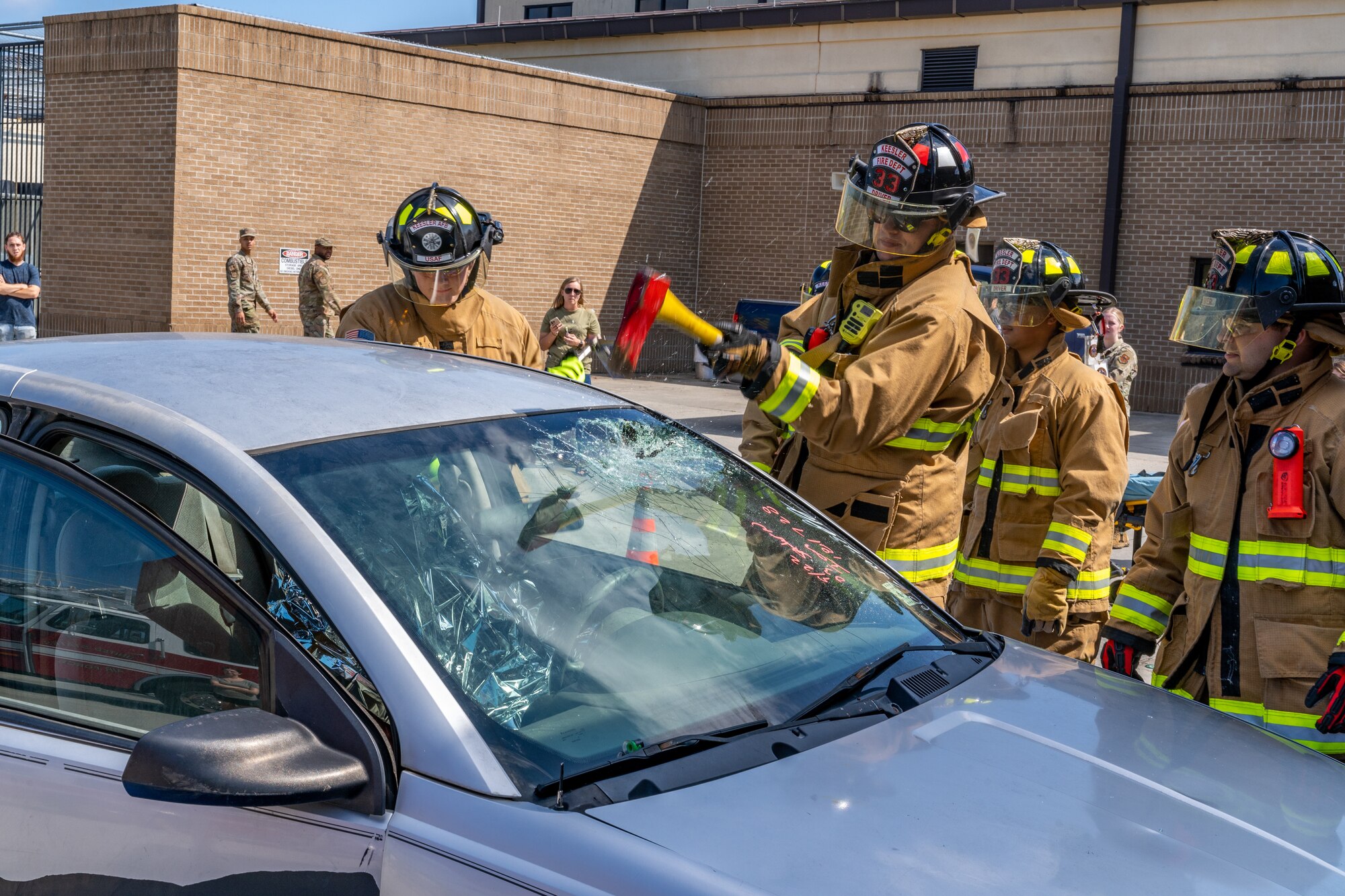 Keesler firefighters simulate rescuing a victim of a motor vehicle accident during the Fire Safety and Preparedness Event at Keesler Air Force Base, Mississippi, Oct. 14, 2023.