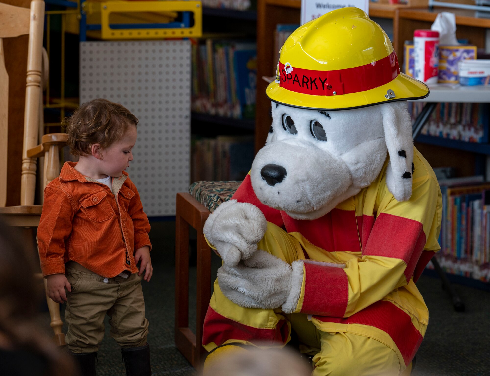 Sparky the Fire Dog, the mascot for National Fire Protection Association, greets a child.