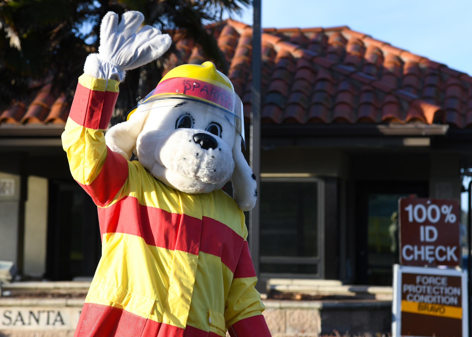 Sparky the Firedog, the National Fire Protection Association mascot, waves at drivers entering the Santa Maria Gate at Vandenberg Space Force Base, Calif., Oct. 13, 2023.