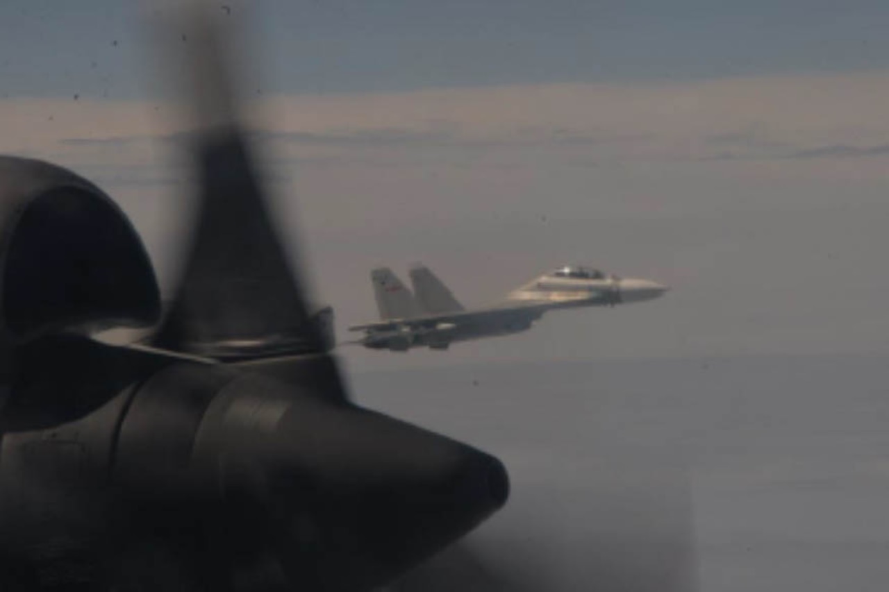 A fighter jet is seen from another aircraft.