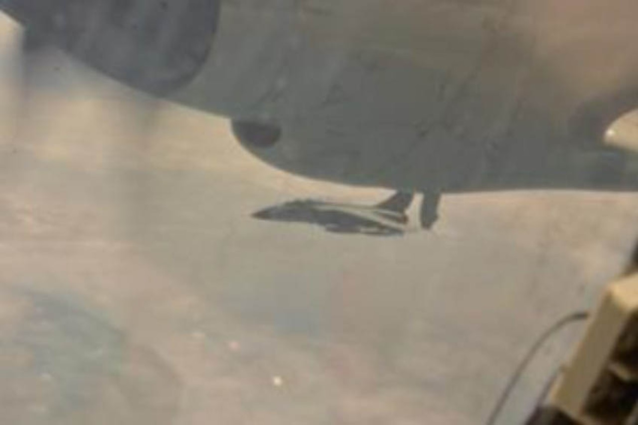 A fighter jet is seen from another aircraft.