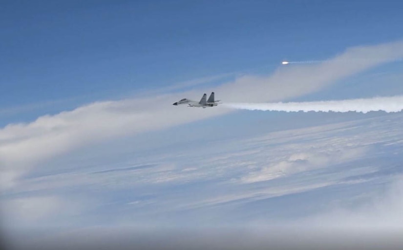 A fighter jet flies across the sky.