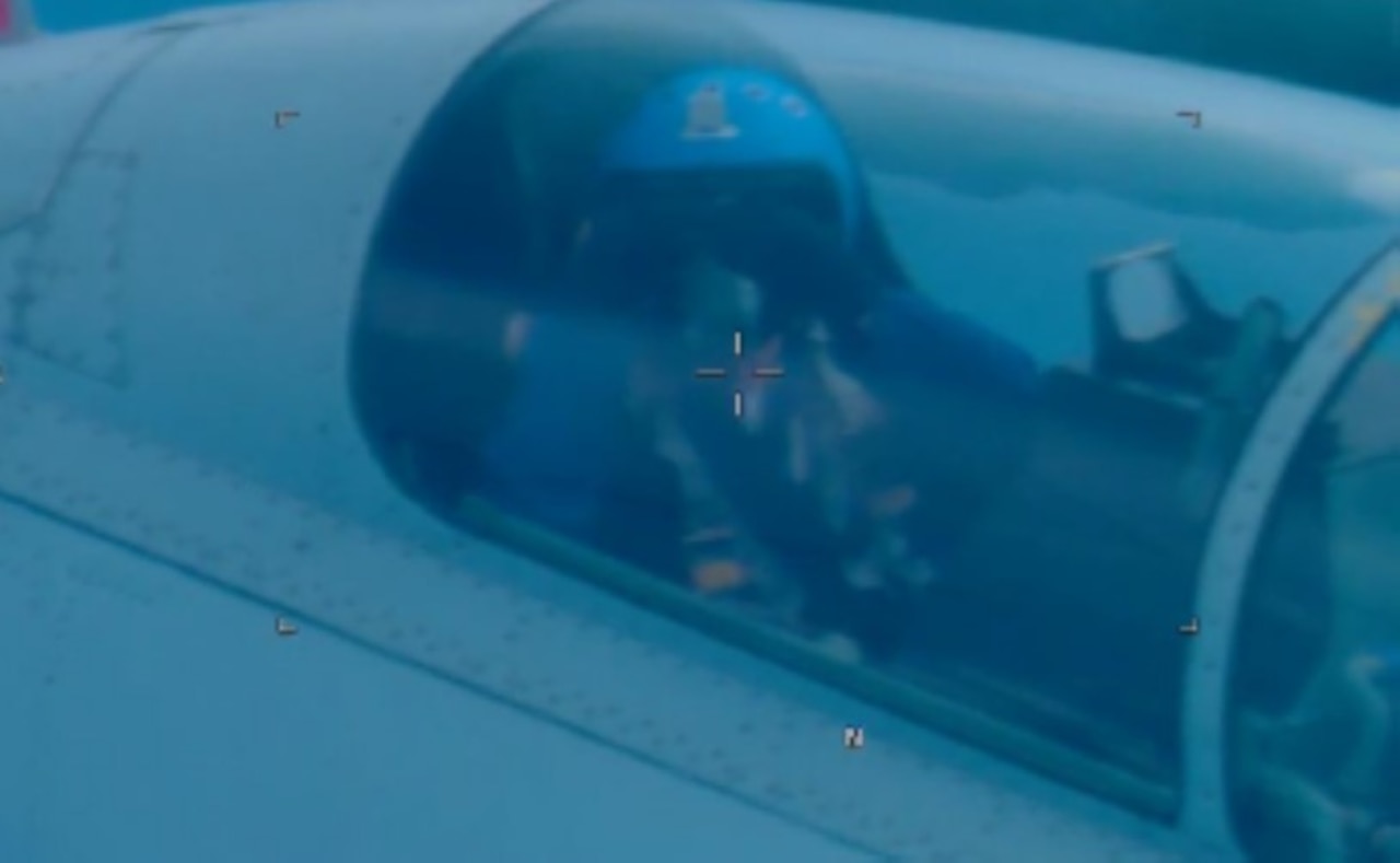 A close-up of an pilot in the cockpit of an aircraft.
