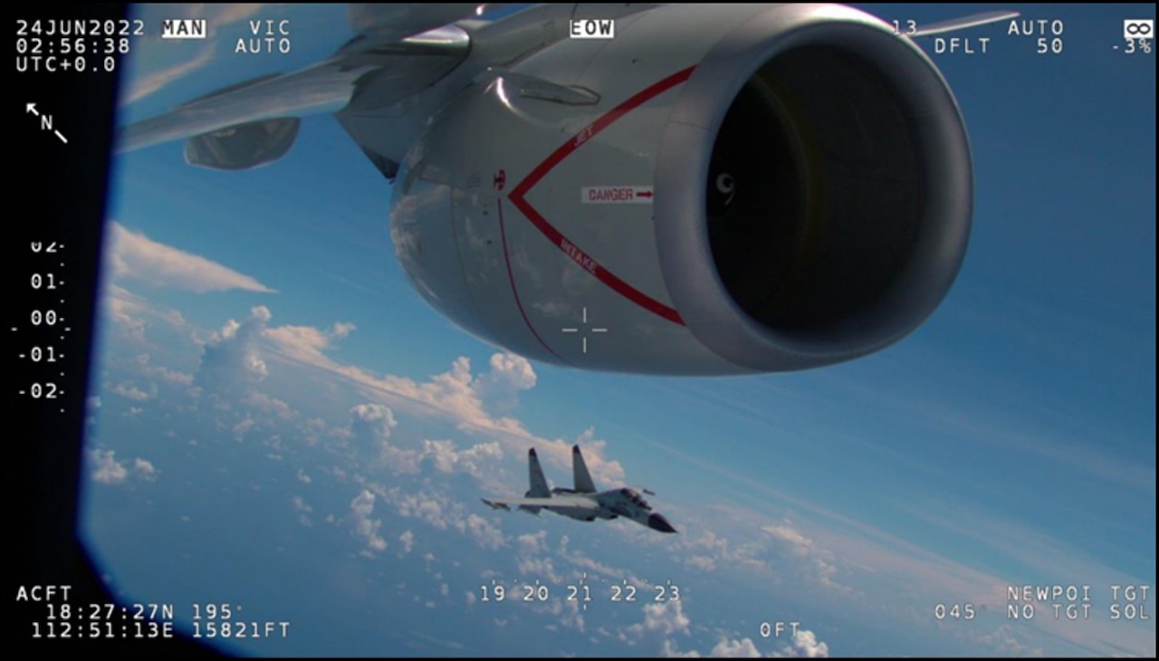 An aircraft flies next to another aircraft.