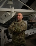 Air Force Master Sgt. Ryan Colon, pictured here as a technical sergeant with the Florida Air National Guard’s 114th Electromagnetic Warfare Squadron, poses in front of space-based equipment at Patrick Air Force Base, Florida, June 29, 2022. Colon is the first enlisted Airman in the Air National Guard to graduate from the Space Warfighter Advanced Instructor Course at the U.S. Air Force Weapons School in Nellis Air Force Base, Nevada.