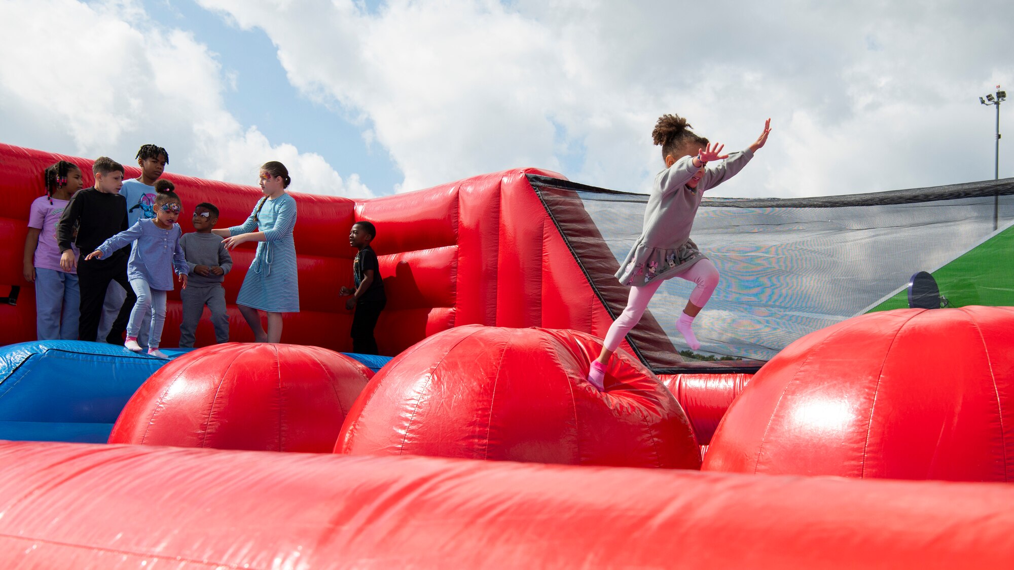 a girl jumps on an inflatable bouncy toy
