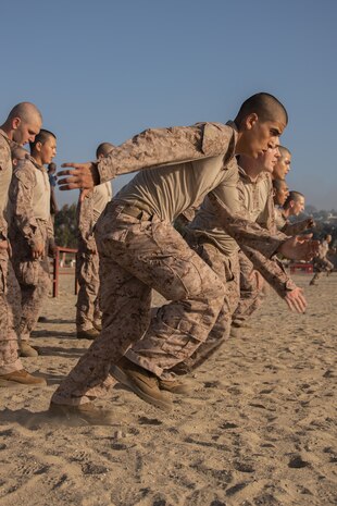 U.S. Marine Corps recruits with Lima Company, 3rd Recruit Training Battalion, conduct warm-up exercises during before the confidence course at Marine Corps Recruit Depot San Diego, Oct. 16, 2023. Recruits became physically and mentally stronger by overcoming obstacles that require strength, balance, and determination. (U.S. Marine Corps photo by Lance Cpl. Janell B. Alvarez)