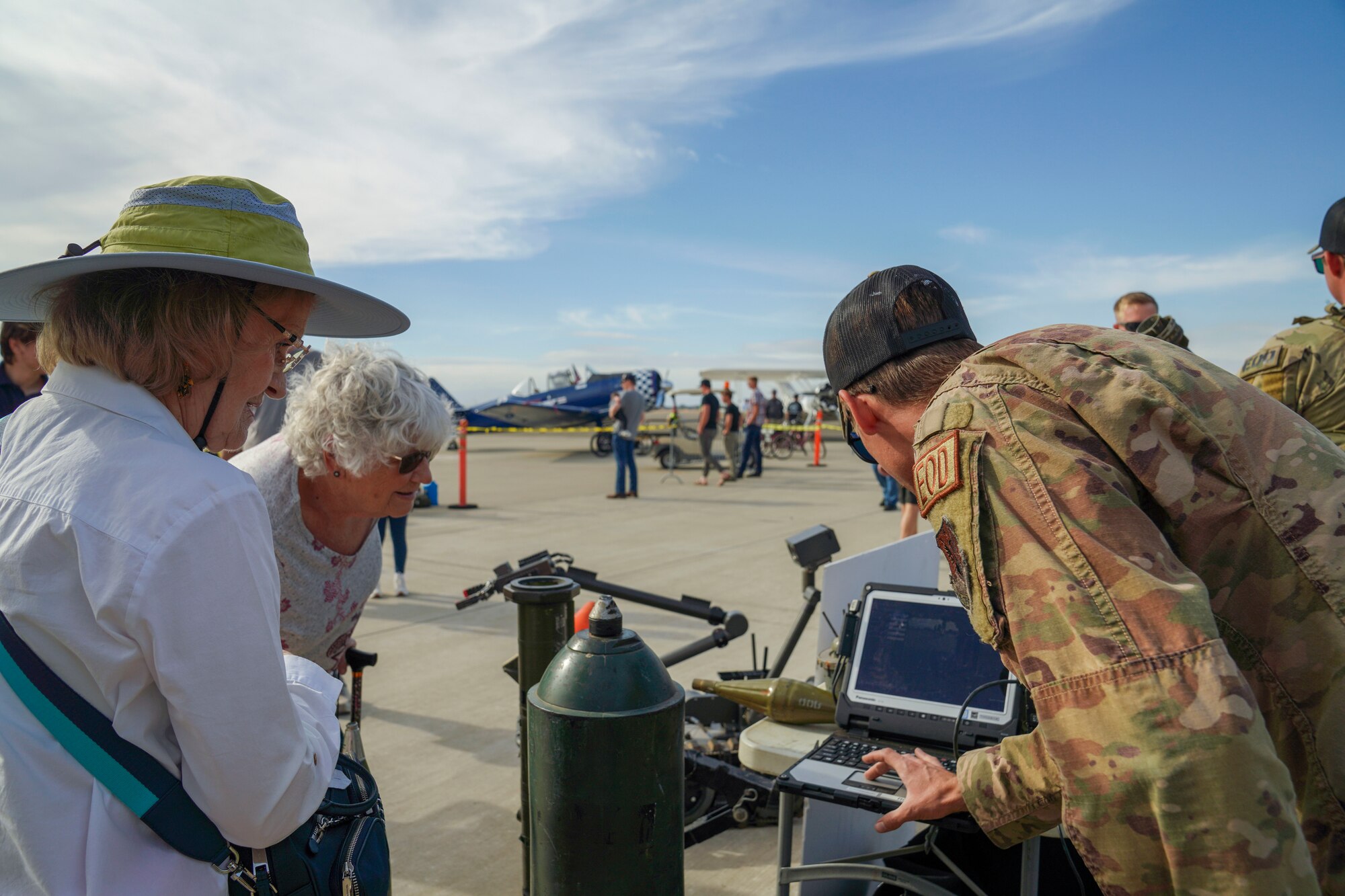 U.S. Air Force Staff Sgt. Brandon Romaca, Explosive Ordnance Disposal (EOD) technician, 9th Civil Engineer Squadron, demonstrates how to control the MTRS II Robotics Platform to a community member at the Chico Regional Airport Open House Chico, California on Oct. 14, 2023.
