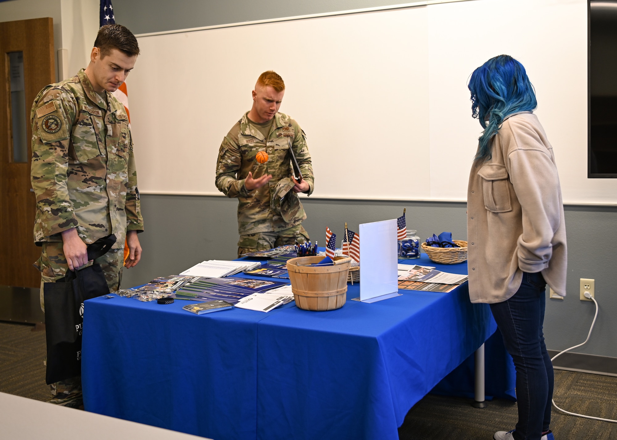 A college representative gives information on how to apply for college during an education center open house.