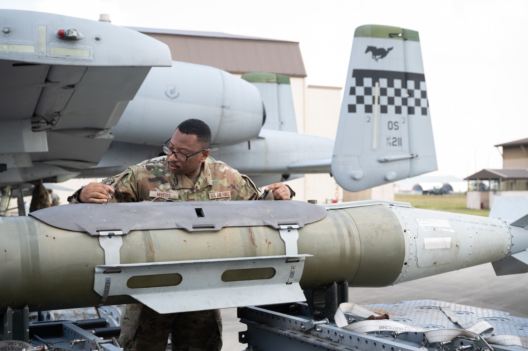 A load crew member, ensures a munition is ready for loading during Pen Fest the annual bilateral munitions load crew competition at Kunsan Air Base