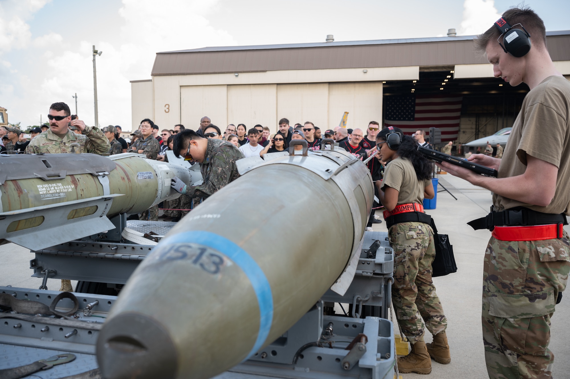 Load crew members prepare their respective munitions during Pen Fest, the annual bilateral munitions load crew competition at Kunsan Air Base