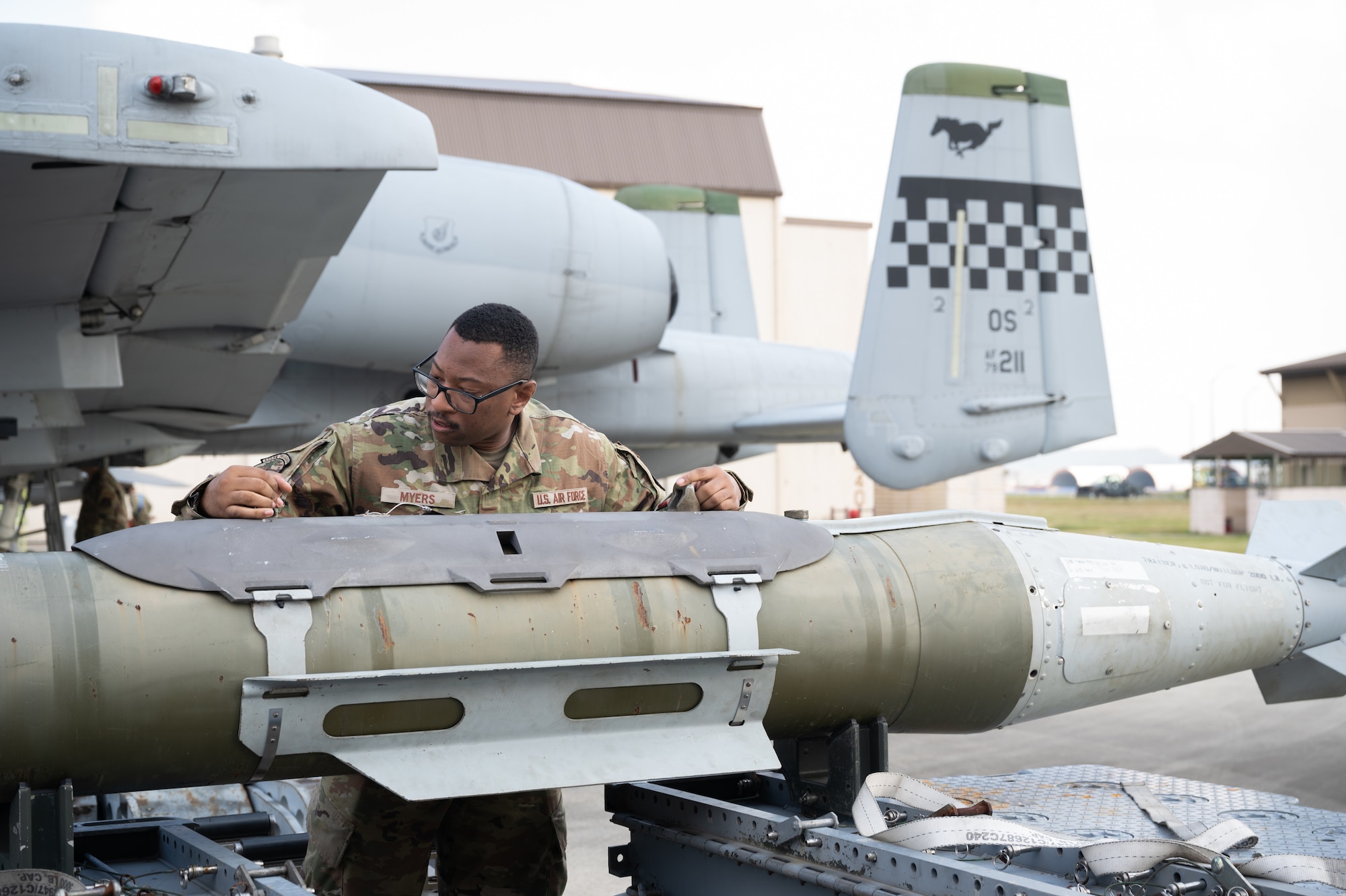 A load crew member, ensures a munition is ready for loading during Pen Fest the annual bilateral munitions load crew competition at Kunsan Air Base