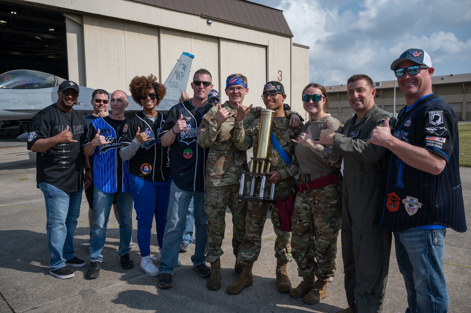 Winners of the annual bilateral munitions load crew competition, 35th Fighter Generation Squadron load crew members, and leaders from the 8th Fighter Wing pose with the Pen Fest trophy at Kunsan Air Base