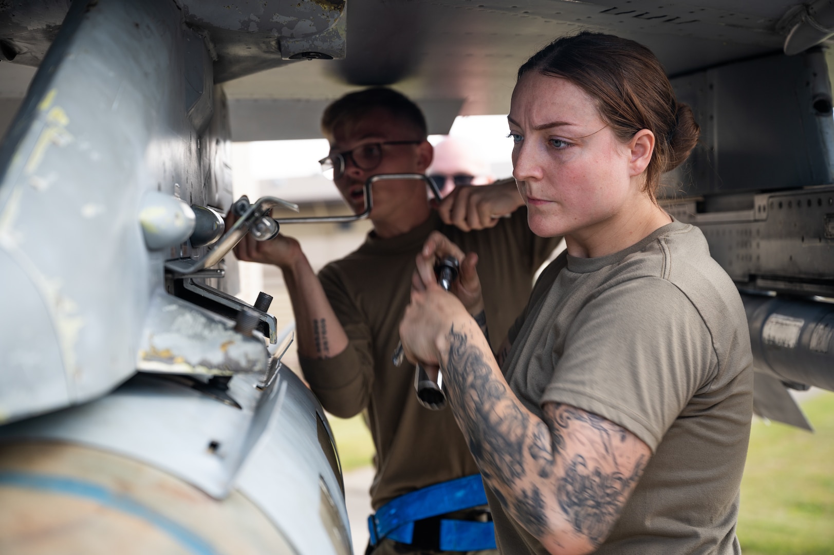 A load crew member, secures a munition during Pen Fest, the annual bilateral munitions load crew competition at Kunsan Air Base