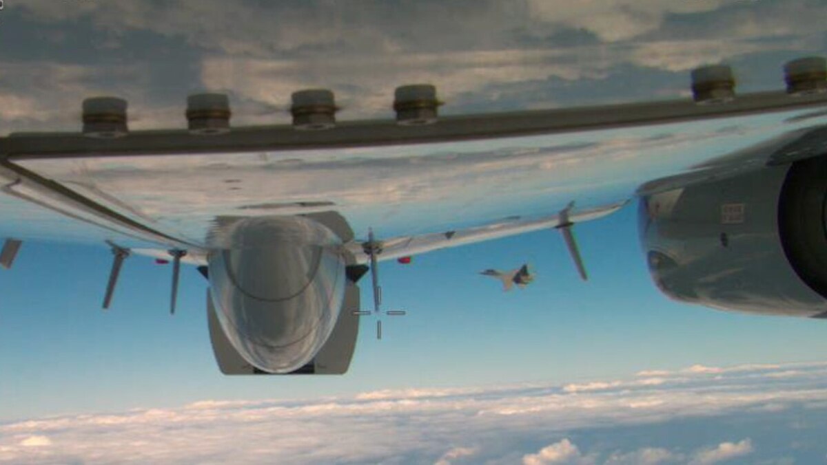 View of a jet flying near another one, which is partly visible in the foreground.