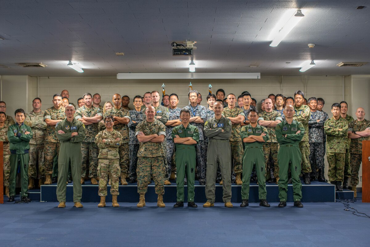 Military personnel pose for a photo.
