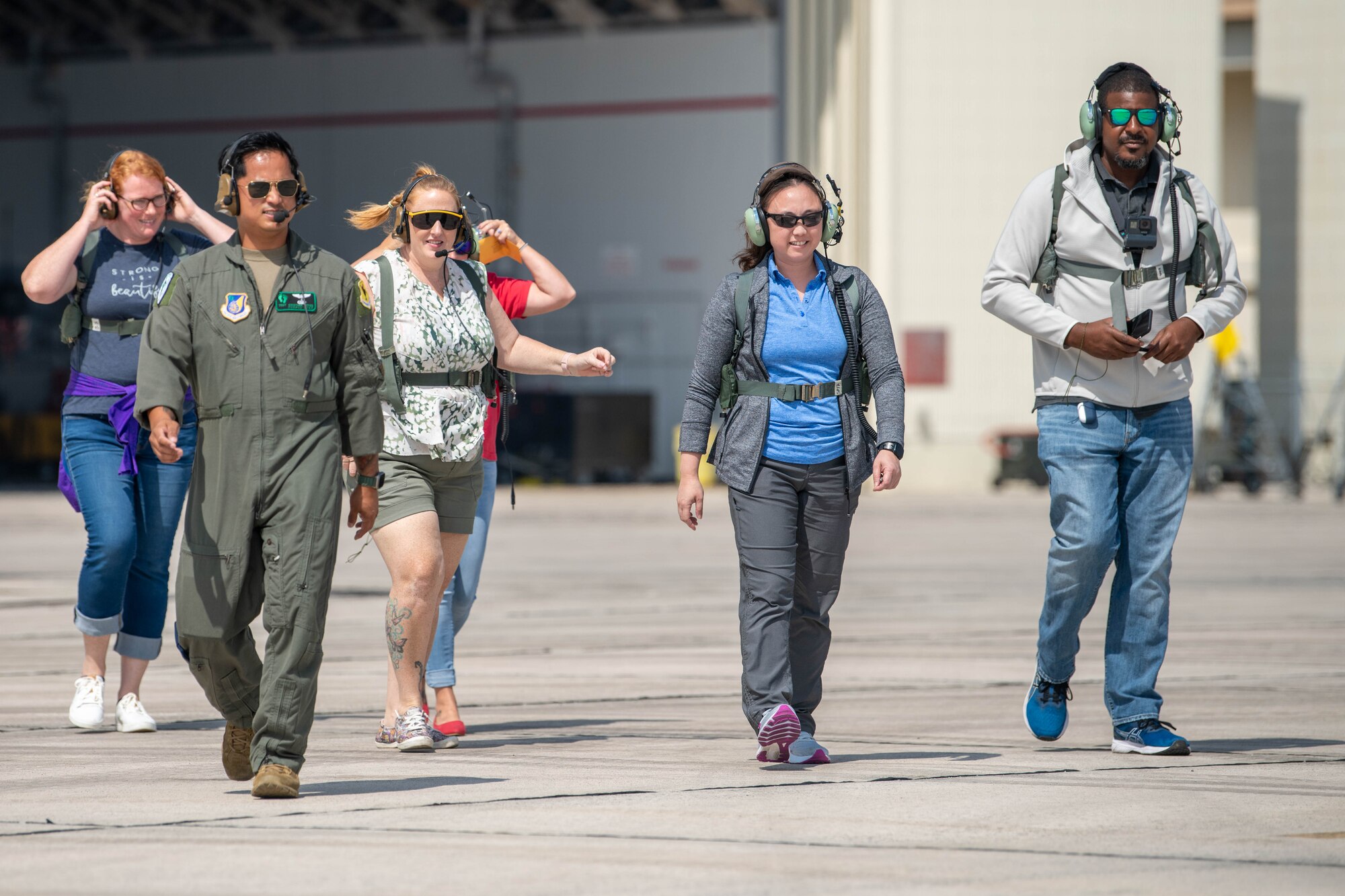 Kadena spouses walk across the flight line preparing to board a helicopter