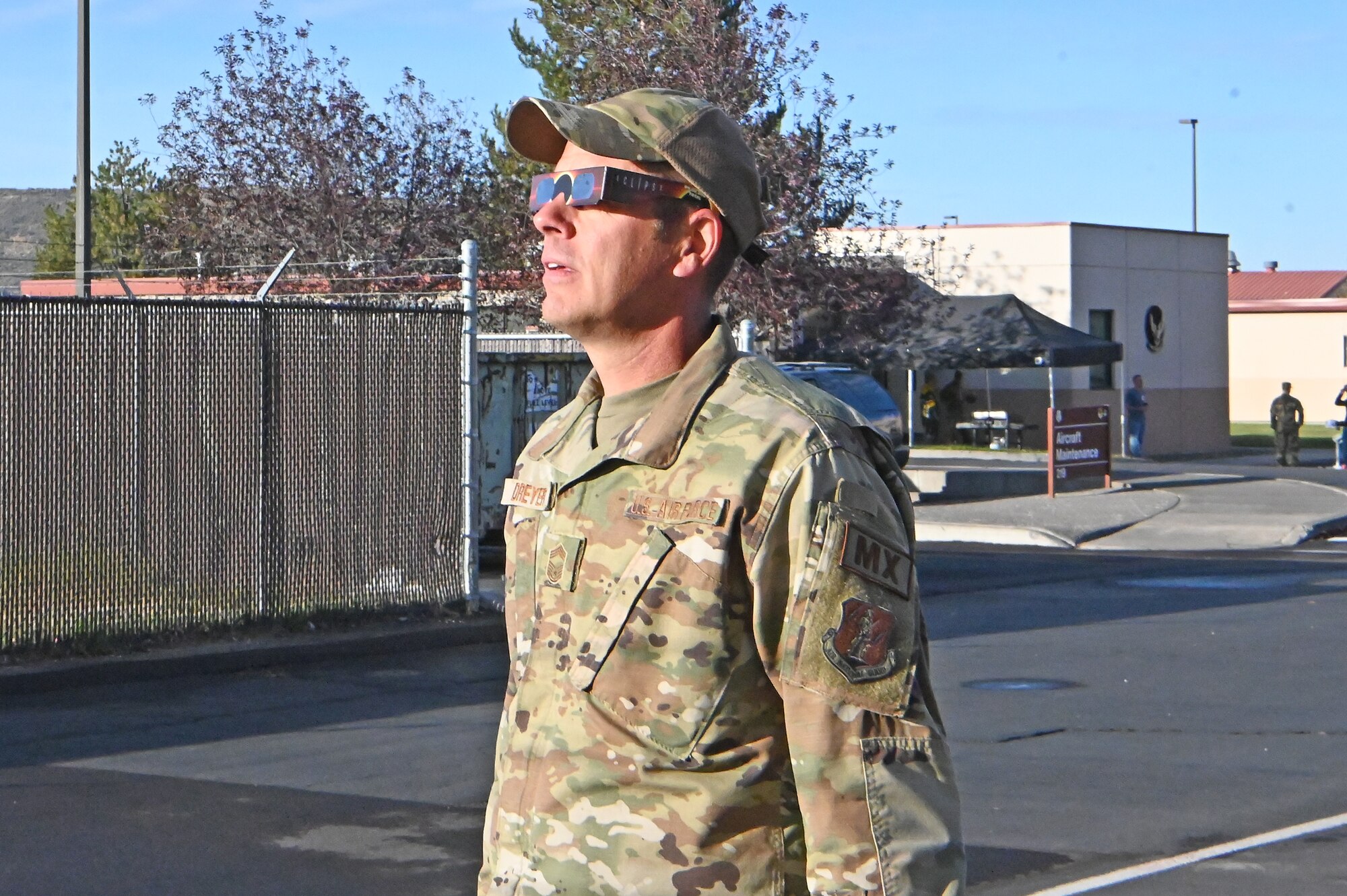 U.S. Air Force Chief Master Sgt. James Dreyer, 173rd Maintenance Group, dons his glasses to view the solar eclipse.