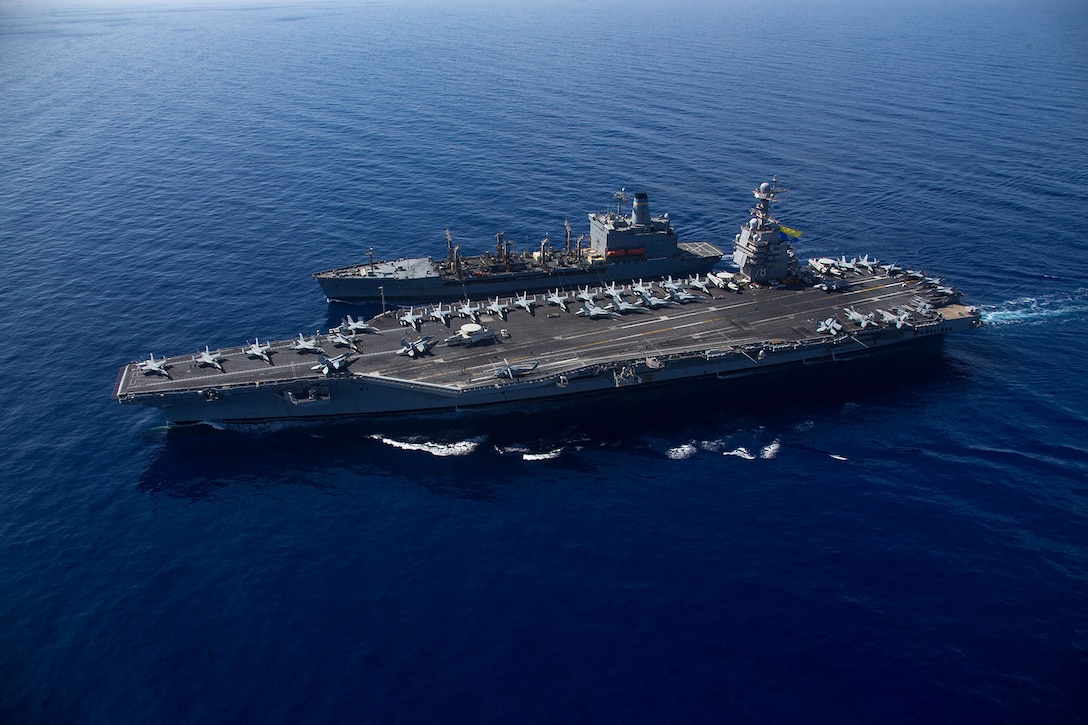 Two ships sail side by side in the Mediterranean Sea.