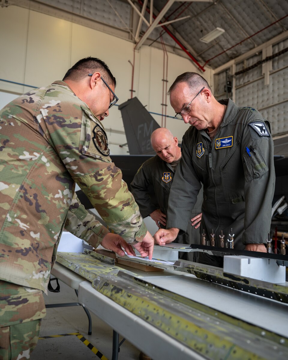 Master Sgt. Ziwei Mao, 482d Maintenance Squadron, briefs Lt. Gen. John P. Healy, Chief of Air Force Reserve, and Col. Joshua Padgett, 482d Fighter Wing Commander, on maintaining the F-16 Fighting Falcon at a workshop in Homestead Air Reserve Base, Florida, on Oct. 15, 2023.