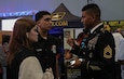 An Army Reserve Soldier speaks to potential recruits about military career opportunities in Puerto Rico. The Army Reserve recently increased the number of career fields of the Army Civilian Acquired Skills Program. Through the ACASP, civilian recruits are rewarded for their experience with a higher rank and pay. (Photo by Sgt. Halayla Vega)