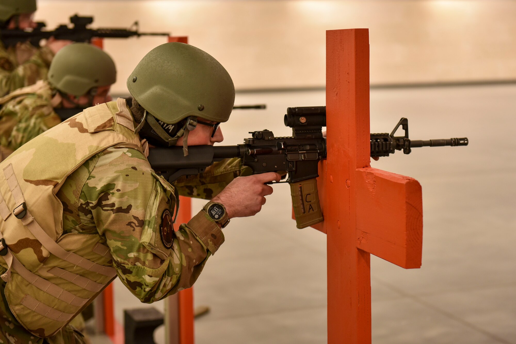 An Airman shoots an M4 Carbine rifle during a Combat Arms Training and Maintenance course.