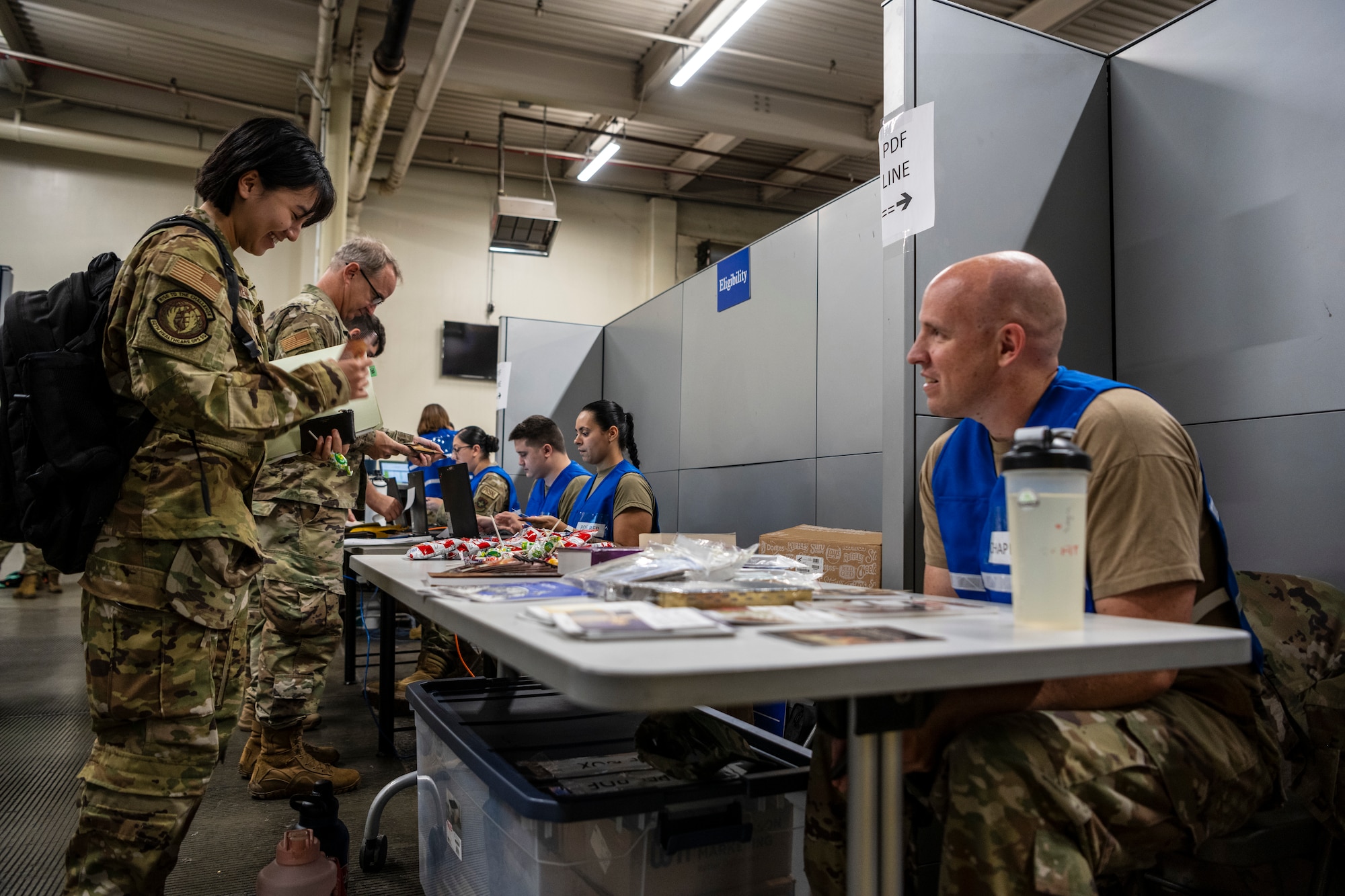 Airmen process through a personnel deployment function line