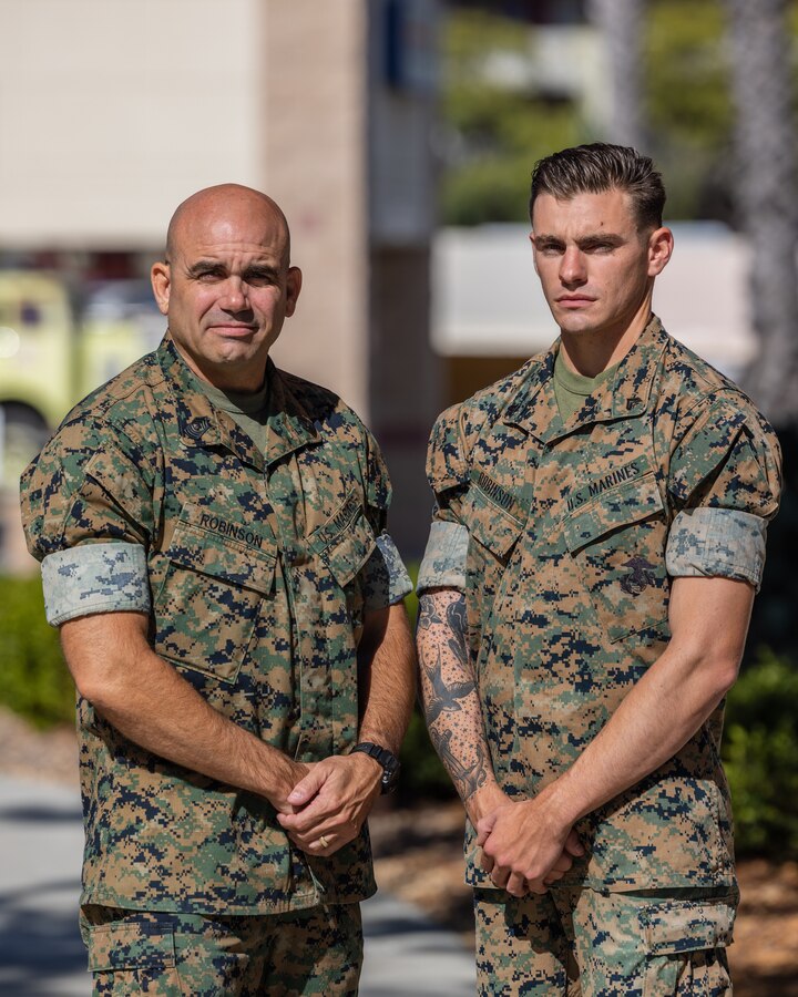 U.S. Marine Corps Master Gunnery Sgt. Robert Robinson, left, the operations chief for 1st Marine Division, and his son, Cpl. Colton Robinson, a team leader with Charlie Company, 1st Battalion, 5th Marine Regiment, 1st MARDIV, pose for a photo at Marine Corps Base Camp Pendleton, California, Oct. 12, 2023. Between the two of them, the Robinsons have over 30 years of service in the Marine Corps. Robert is a native of Medical Lake, Washington. Colton is a native of Lake Forest, Illinois. (U.S. Marine Corps photo by Cpl. Earik Barton)