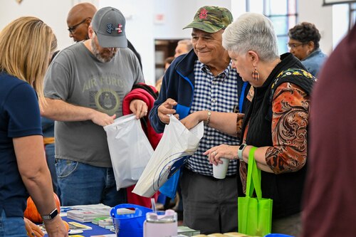 Retirees and dependents receive brochures about various services available to them.