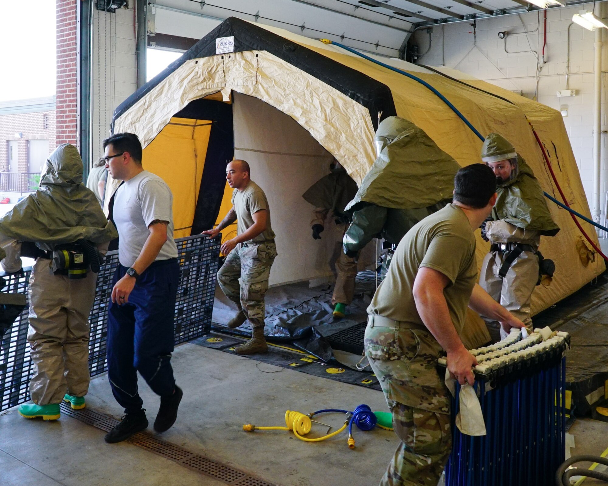 Airmen set up a decontamination tent.